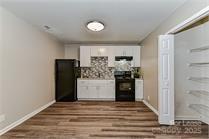 238 Hoskins Mill Lane, Unit D Charlotte, NC 28208 - Photo 11 of 13 a view of a kitchen with refrigerator and window