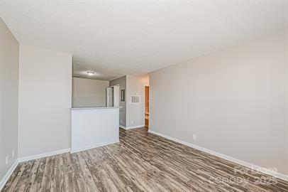 238 Hoskins Mill Lane, Unit D Charlotte, NC 28208 - Photo 3 of 13 a view of an empty room with closet and wooden floor