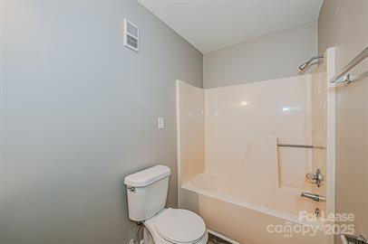 238 Hoskins Mill Lane, Unit D Charlotte, NC 28208 - Photo 8 of 13 a white toilet sitting next to a bath tub