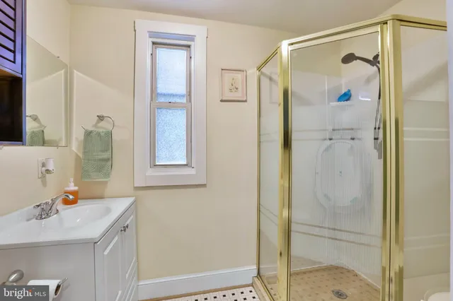 a bathroom with a shower sink and mirror