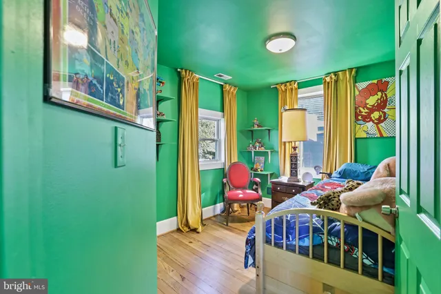 a bedroom with furniture and a large window