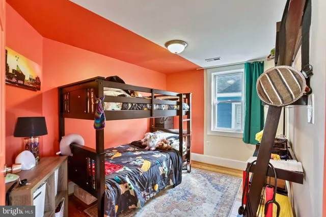 a bedroom with bed and a window