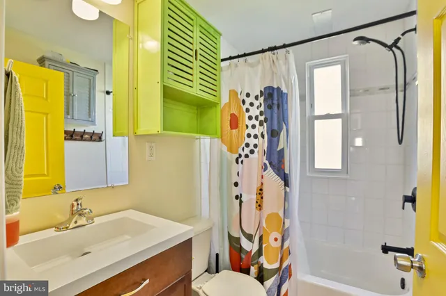 a bathroom with a sink mirror vanity and toilet