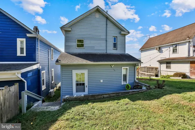 a view of a house with wooden fence