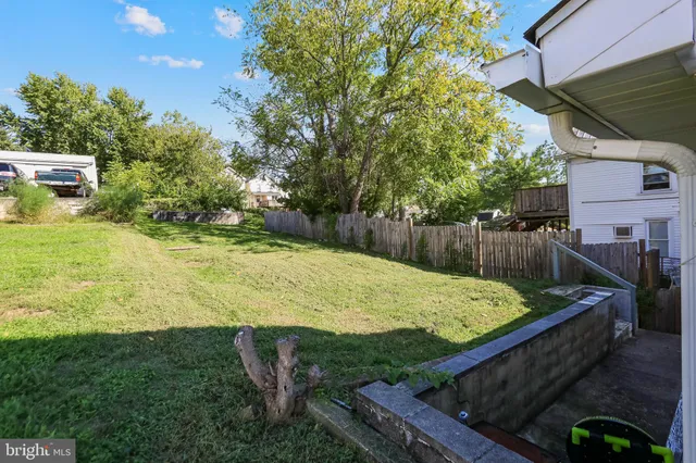 a view of a backyard with wooden fence