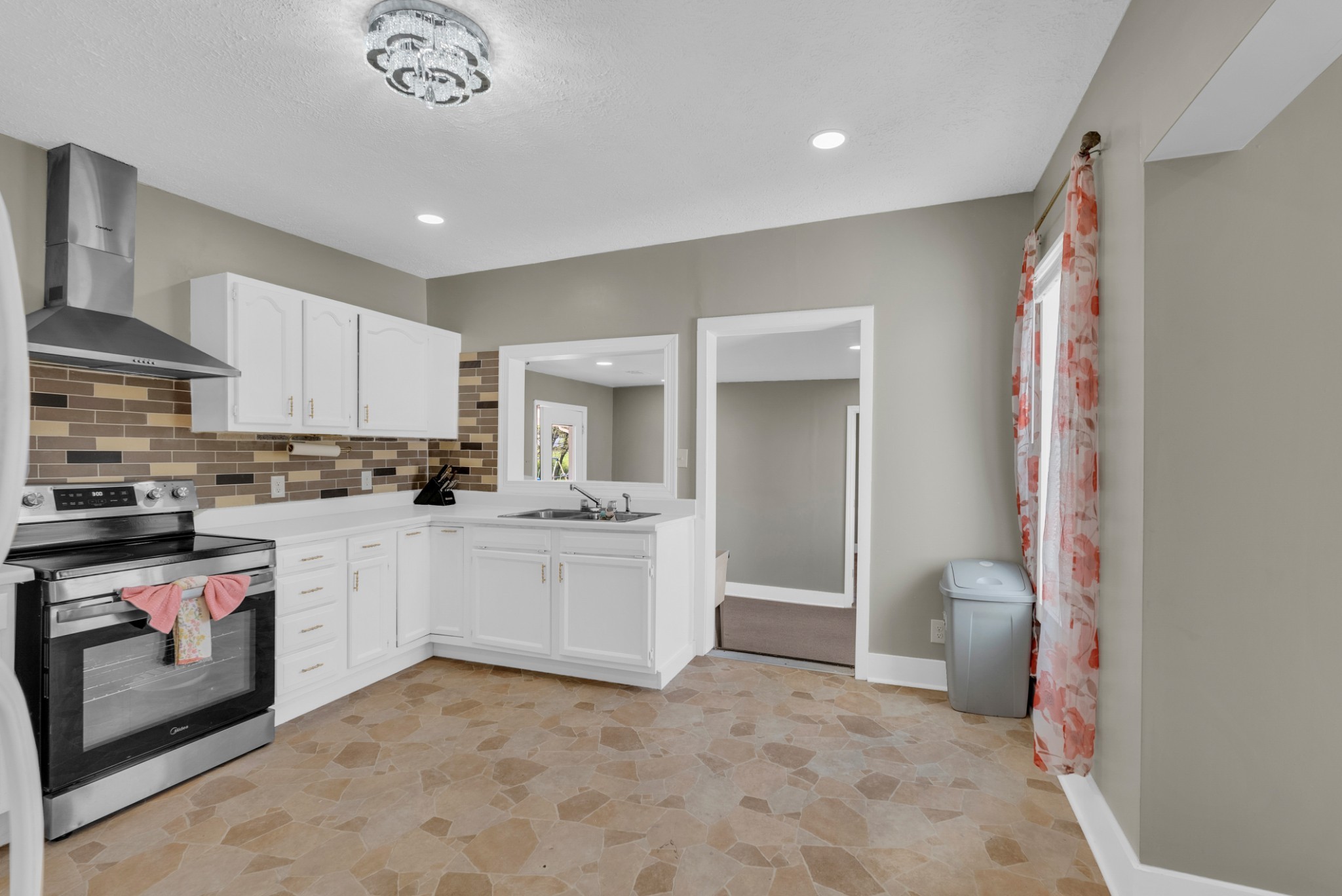 320 West King Street Morrison, TN 37357 - Photo 14 of 29 a kitchen with a sink and white cabinets