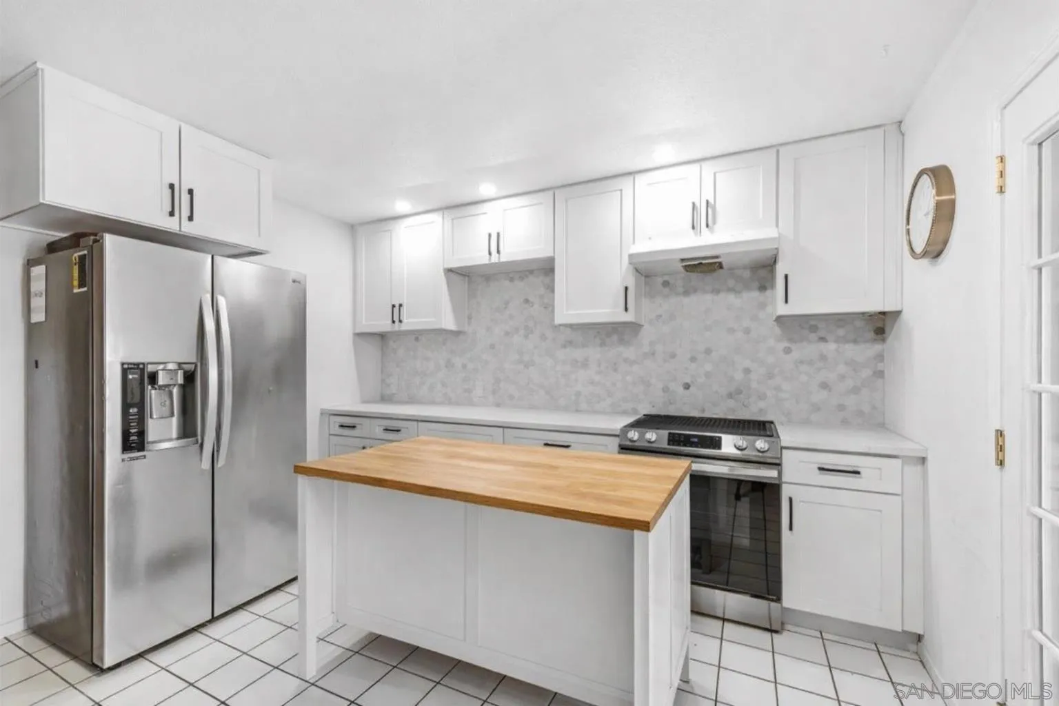 a kitchen with stainless steel appliances a refrigerator sink and microwave