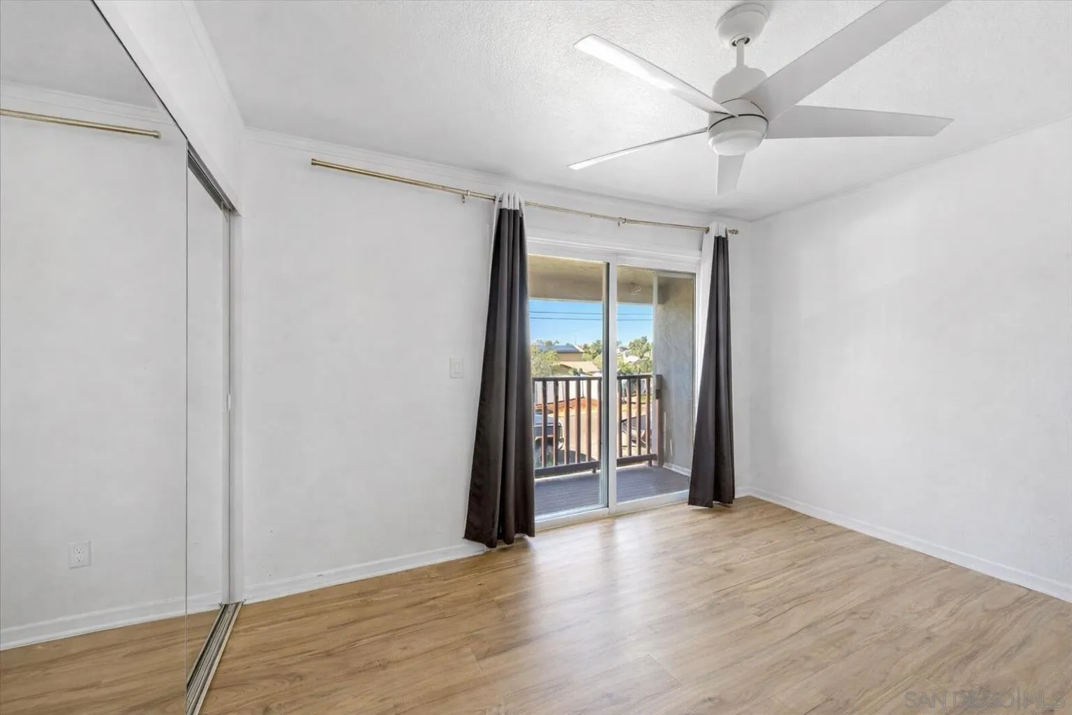 2127 Berry Street Lemon Grove, CA 91945 - Photo 14 of 25 an empty room with wooden floor and fan