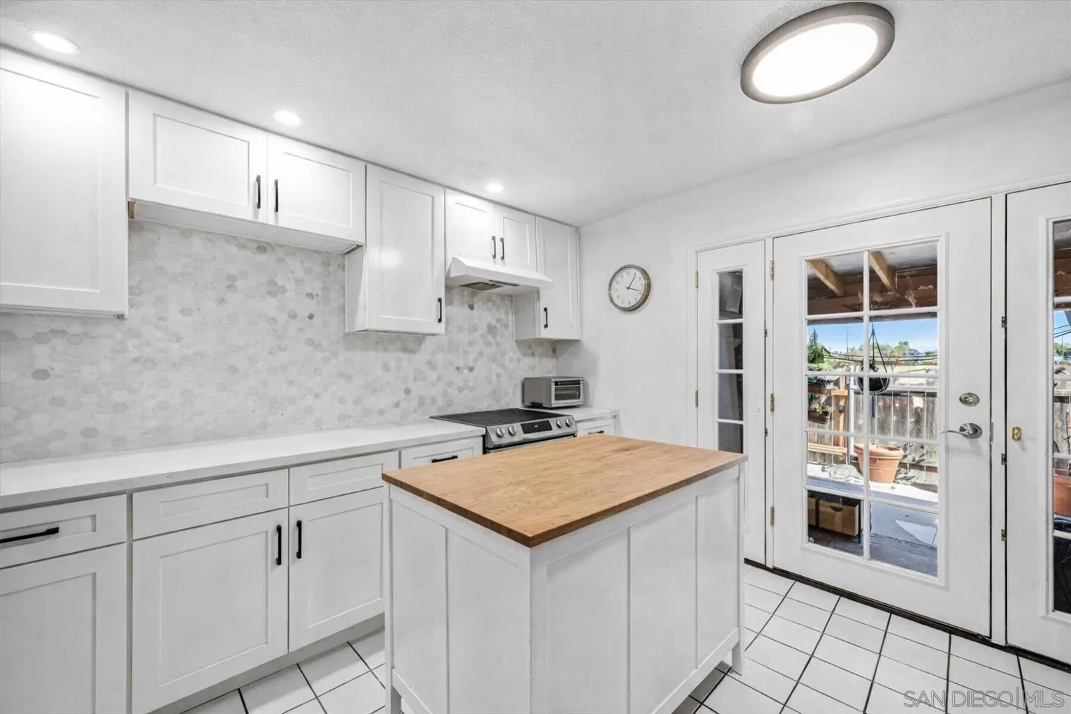 2127 Berry Street Lemon Grove, CA 91945 - Photo 3 of 25 a kitchen with white cabinets and sink