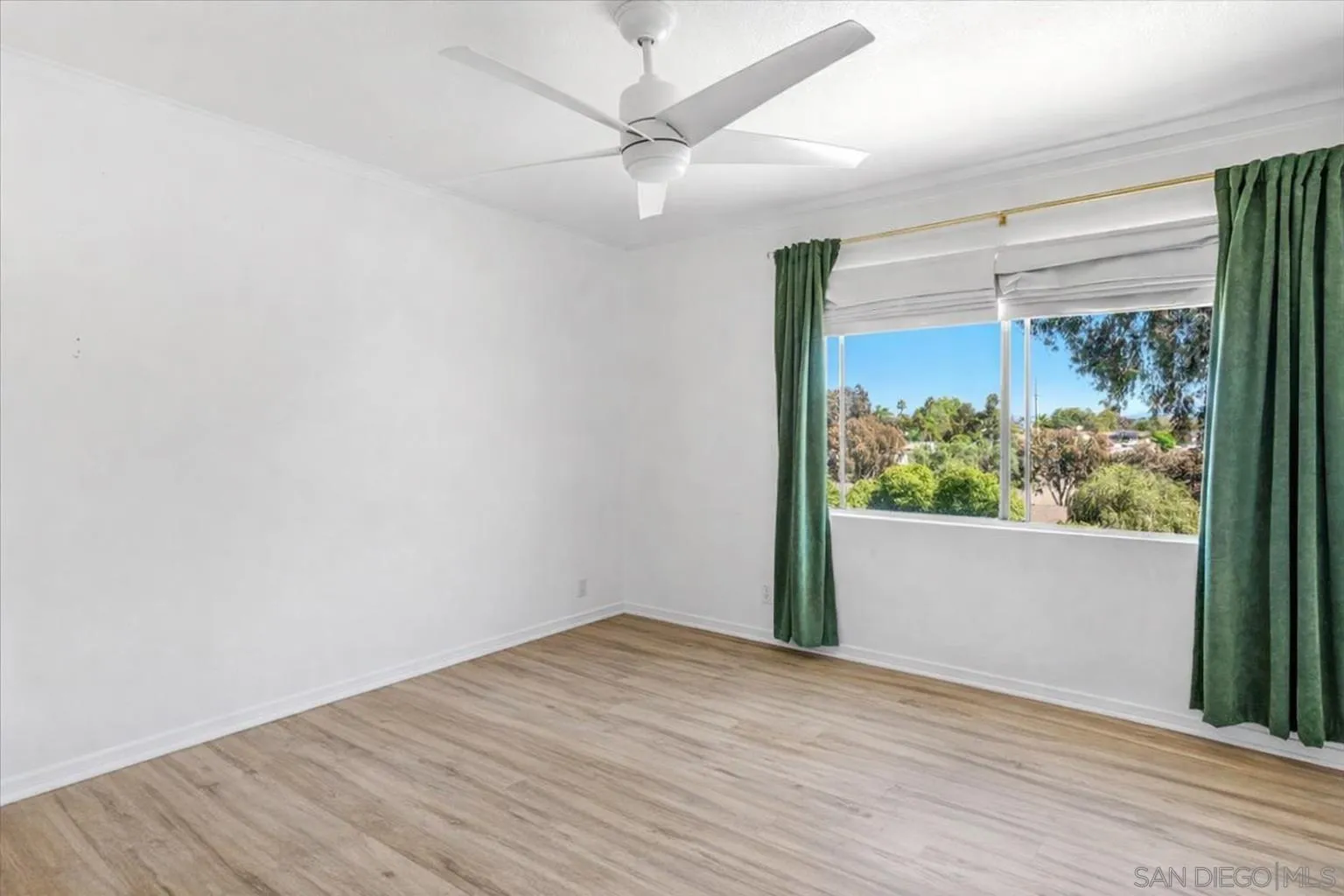 2127 Berry Street Lemon Grove, CA 91945 - Photo 7 of 25 an empty room with wooden floor and windows