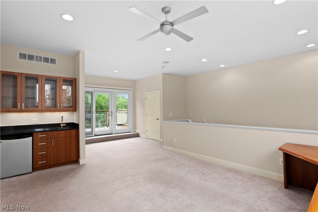 12480 Cedar Road, Unit 14 Cleveland, OH 44106 - Photo 25 of 35 Wet bar, mini fridge, and access to rooftop deck
