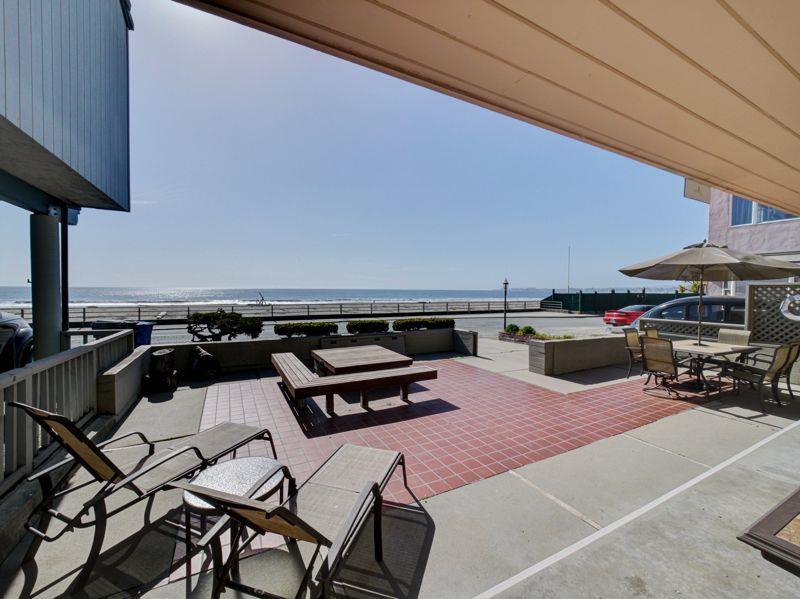 309 Beach Drive Aptos, CA 95003 - Photo 3 of 14 a roof deck with table and chairs under an umbrella