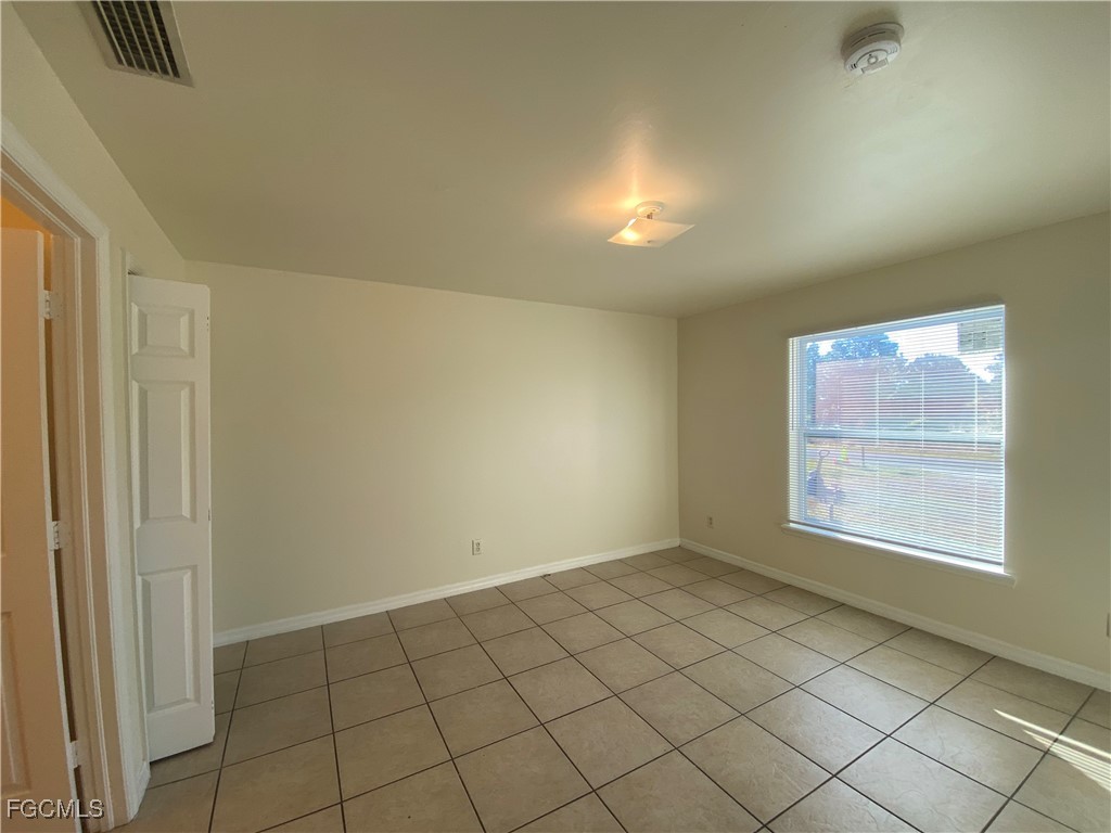 4622 15th Street Southwest Lehigh Acres, FL 33973 - Photo 6 of 15 an empty room with windows