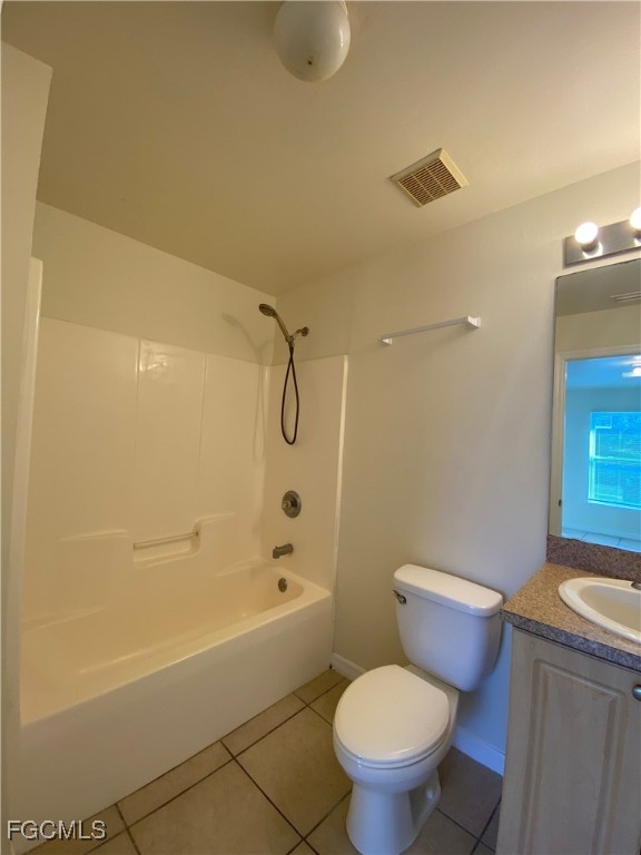 4622 15th Street Southwest Lehigh Acres, FL 33973 - Photo 8 of 15 a white toilet sitting next to a bath tub