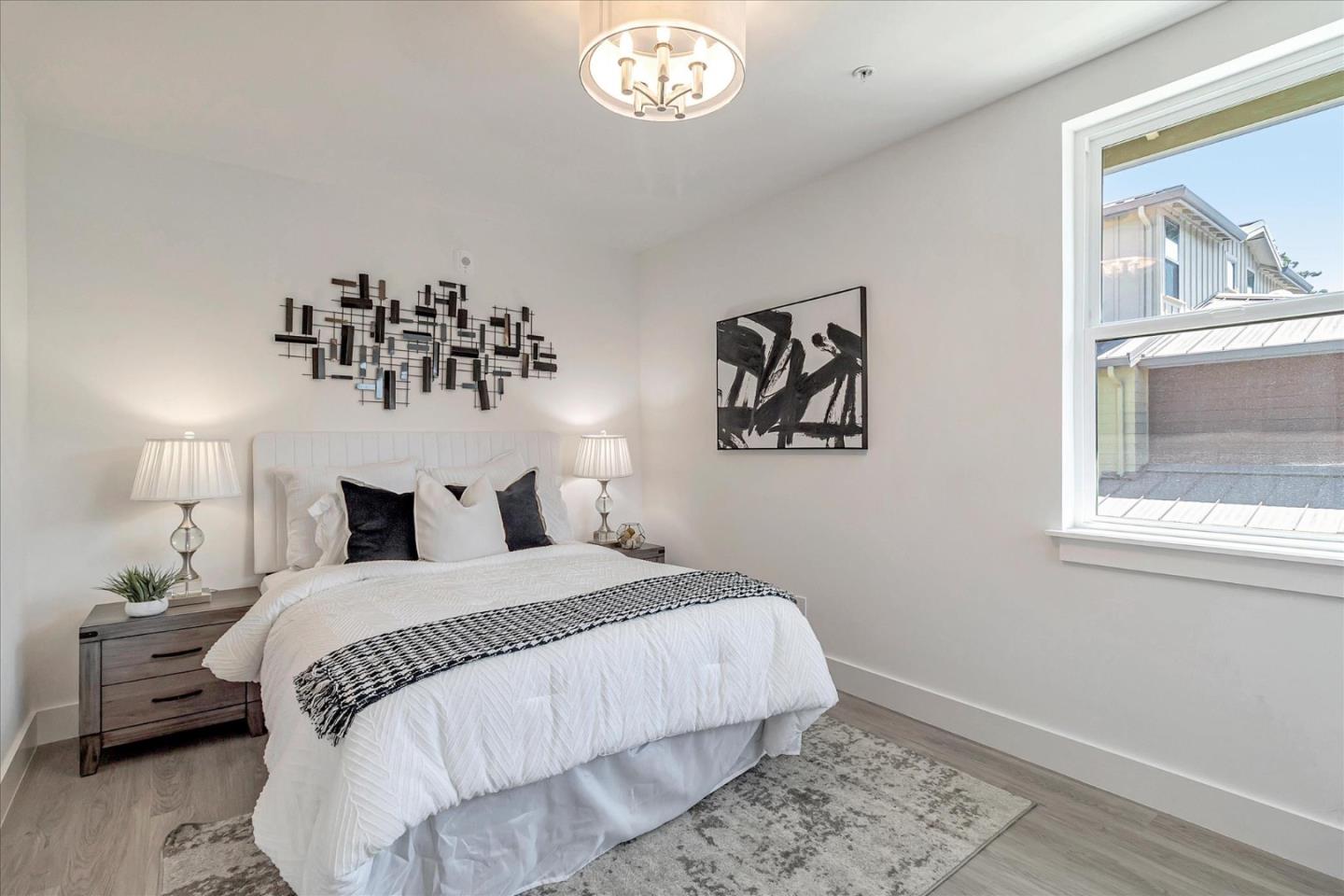 1998 Montecito Avenue Mountain View, CA 94043 - Photo 19 of 29 a bedroom with a bed and a chandelier