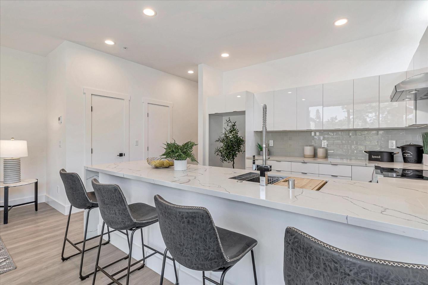 1998 Montecito Avenue Mountain View, CA 94043 - Photo 8 of 29 a kitchen with a dining table chairs and white cabinets