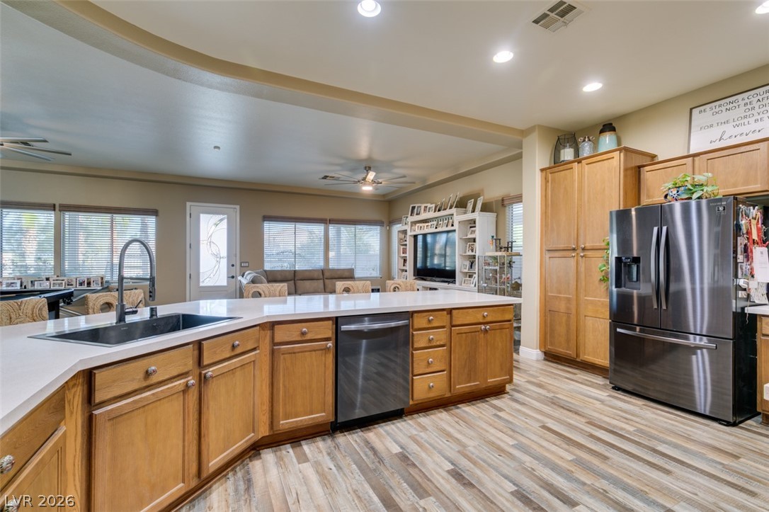 7524 Midnight Rambler Street Las Vegas, NV 89149 - Photo 28 of 51 An open-concept living space highlights a large kitchen island and wood-plank flooring.