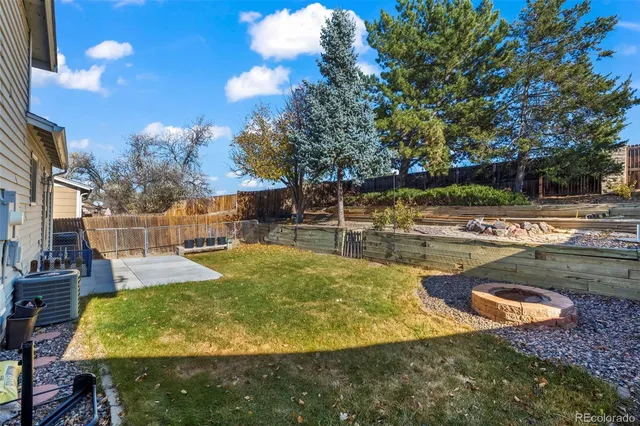 a view of a swimming pool with an outdoor seating and a yard