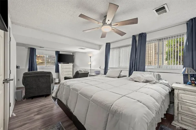 a bedroom with a bed and ceiling fan