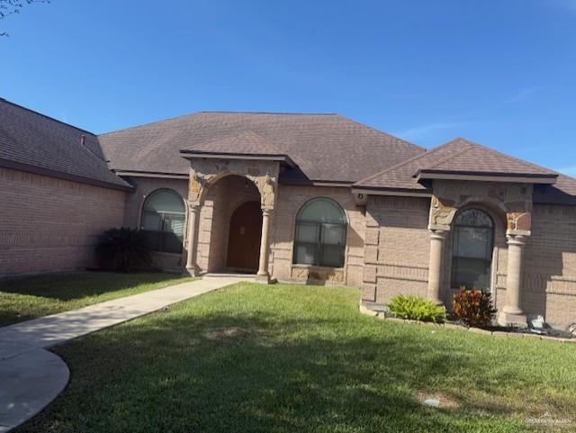 1701 North Ebony Street Pharr, TX 78577 - Photo 1 of 4 a front view of a house with a yard