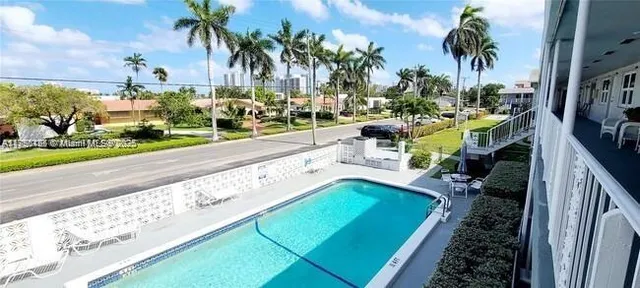 a view of a backyard with swimming pool