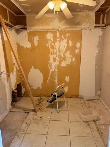 a bathroom with a granite countertop shower and a mirror