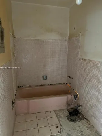 a view of a hallway with furniture and a livingroom view