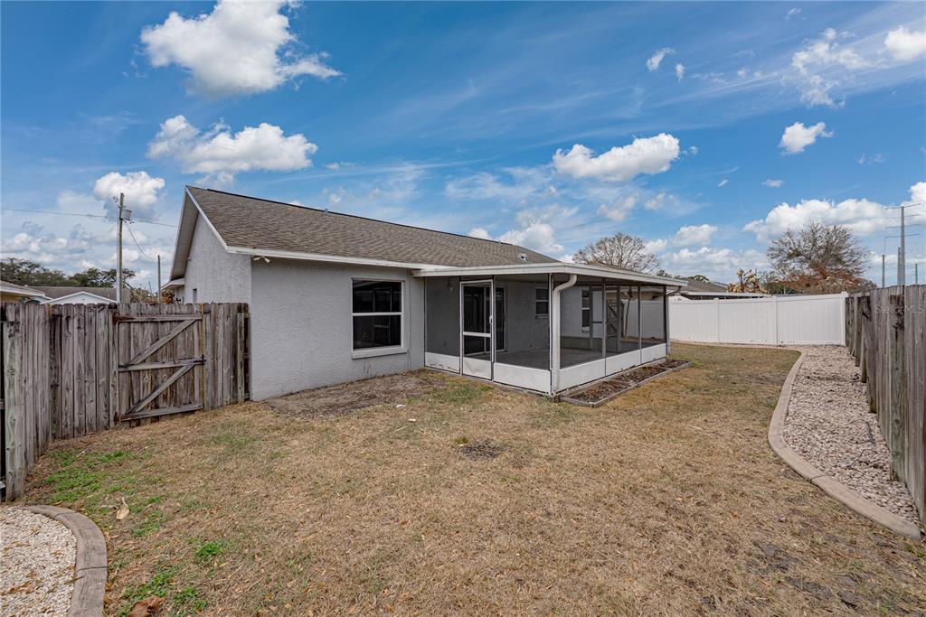 4752 Timber Way Zephyrhills, FL 33542 - Photo 44 of 46 a view of a house with a backyard