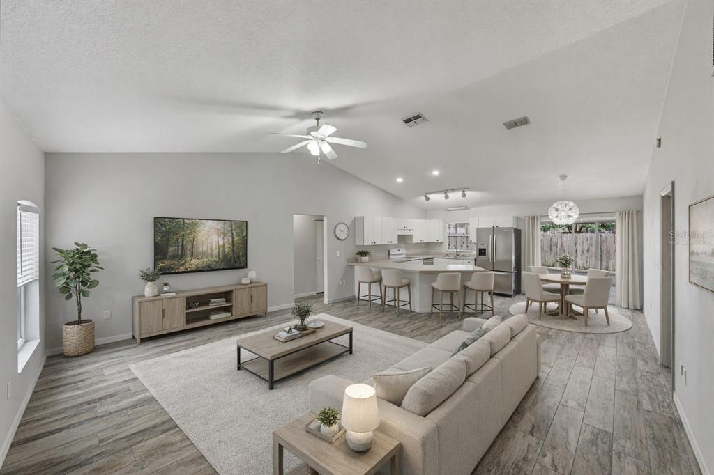 4752 Timber Way Zephyrhills, FL 33542 - Photo 8 of 46 a living room with furniture and a flat screen tv