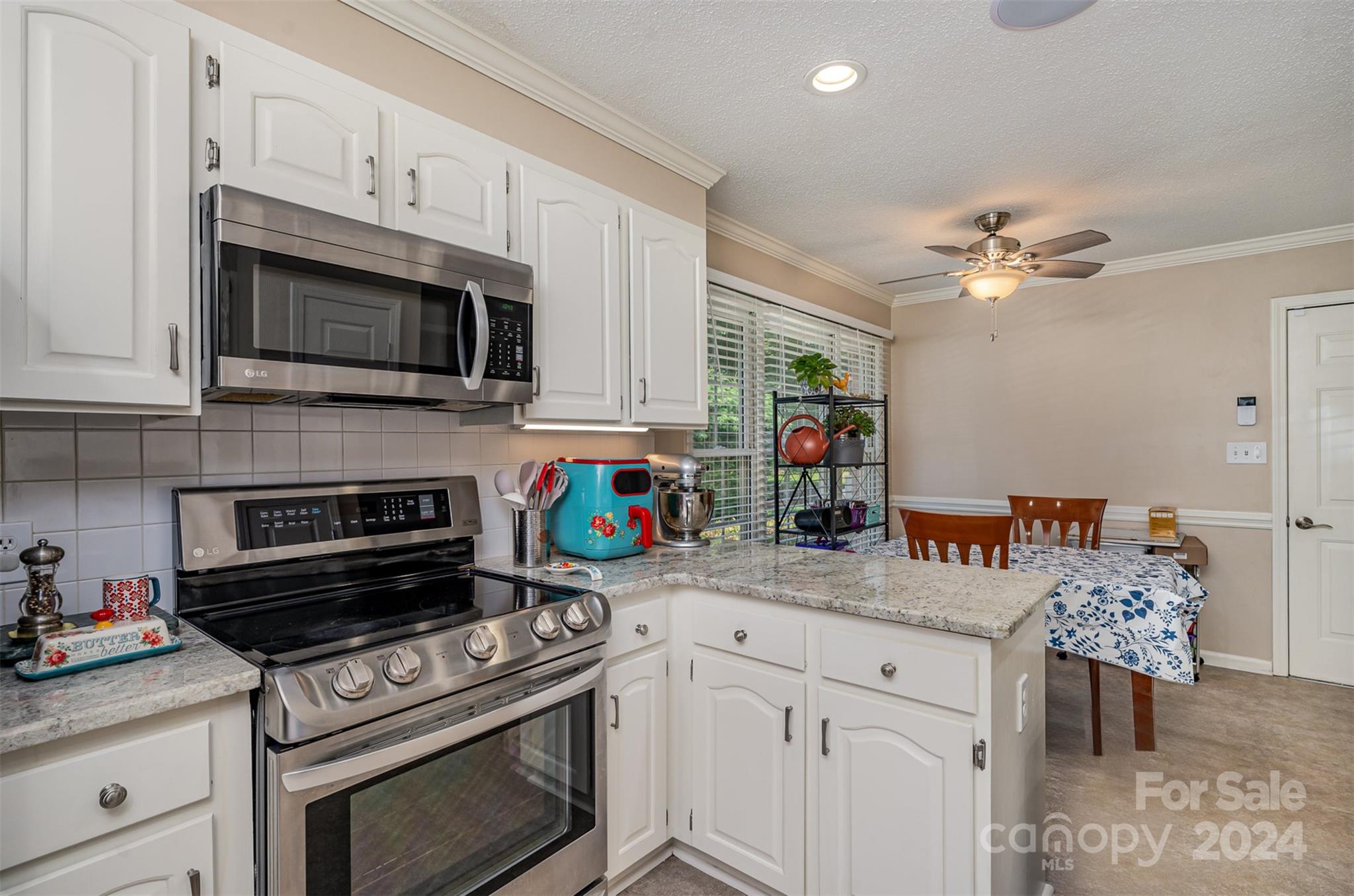 708 1st Avenue North Conover, NC 28613 - Photo 12 of 26 a kitchen with stainless steel appliances a stove microwave and cabinets