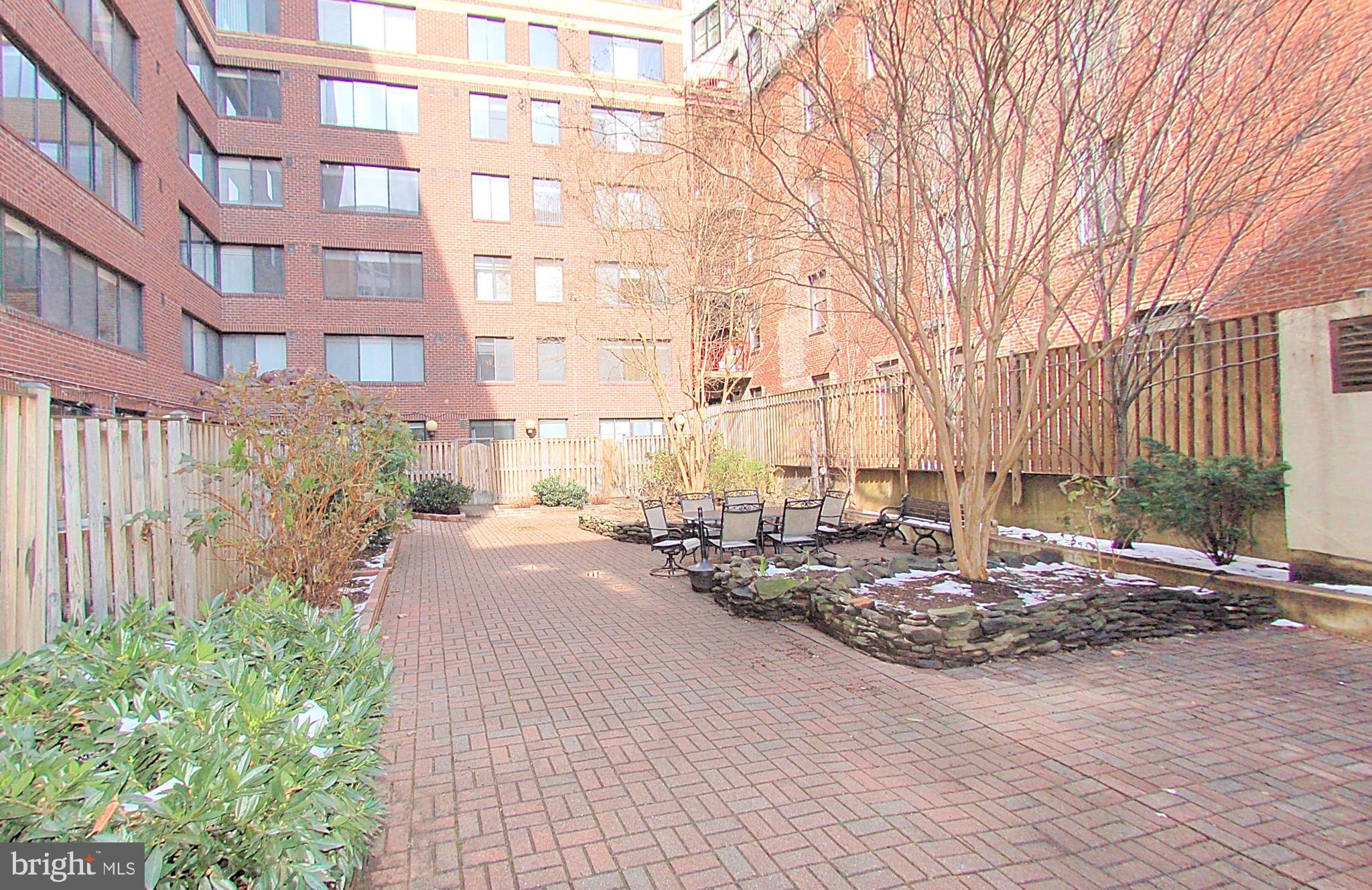 1245 13th Street Northwest, Unit 615 Washington, DC 20005 - Photo 15 of 18 a view of a brick building next to a yard