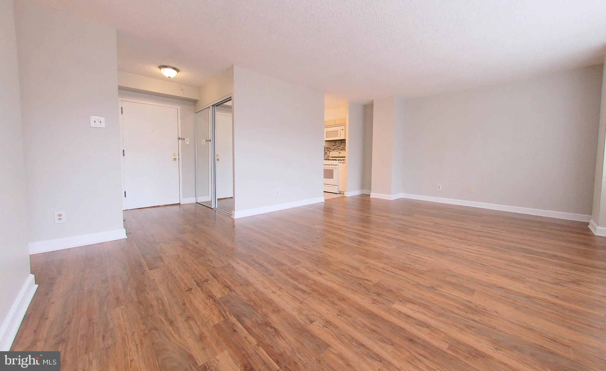 1245 13th Street Northwest, Unit 615 Washington, DC 20005 - Photo 6 of 18 a view of an empty room with wooden floor and a window