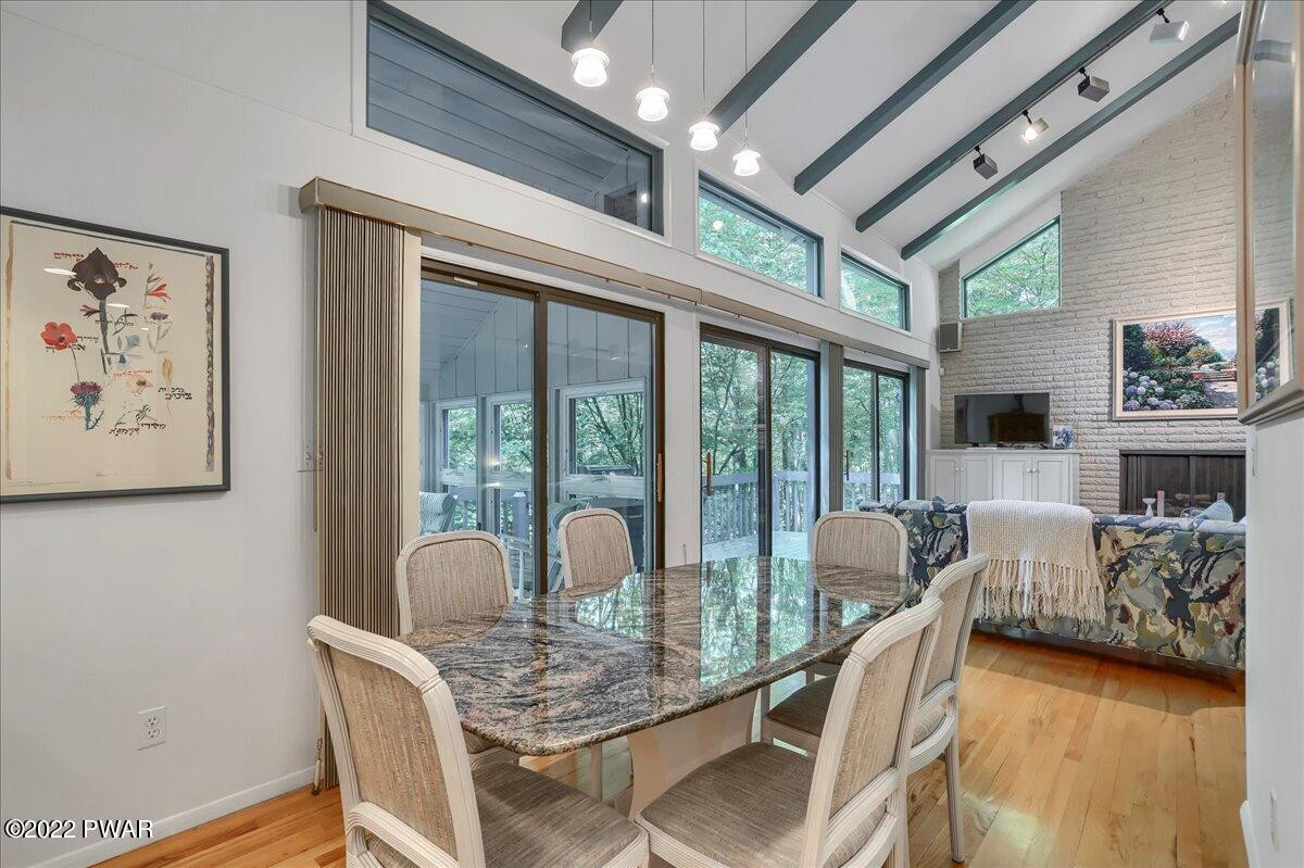 110 Ridge Road Hawley, PA 18428 - Photo 10 of 49 a dining room with furniture a fireplace and wooden floor