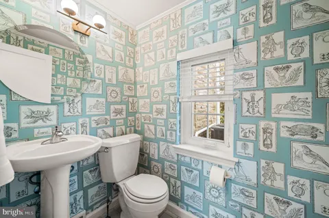 a bathroom with a sink a toilet and a mirror