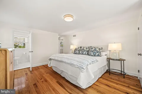 a bedroom with a bed and a lamp on table