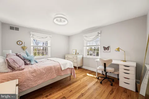 a bedroom with a bed and a desk