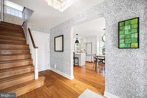 a view of a livingroom with furniture staircase and front door