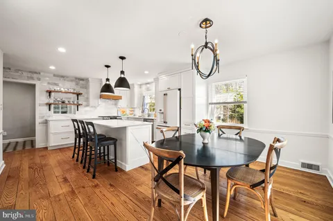 a dining room with furniture and wooden floor