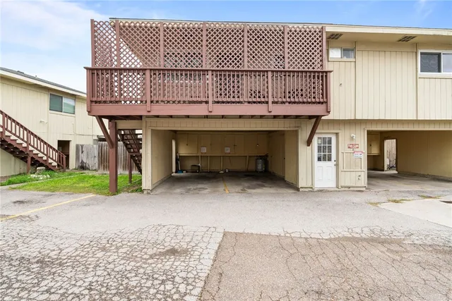 a view of a house with a backyard and a garage