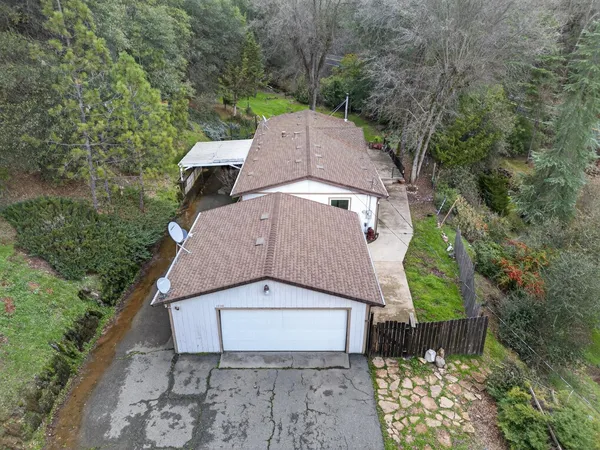 an aerial view of a house with a yard