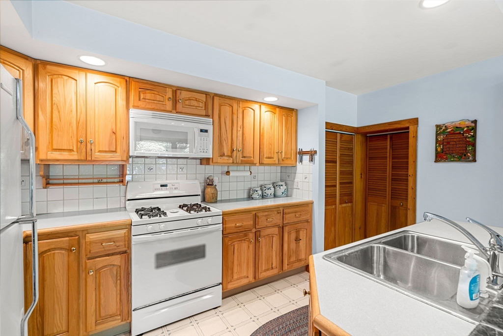 21 Preston Beach Road Marblehead, MA 01945 - Photo 16 of 34 a kitchen with stainless steel appliances granite countertop a sink stove and refrigerator