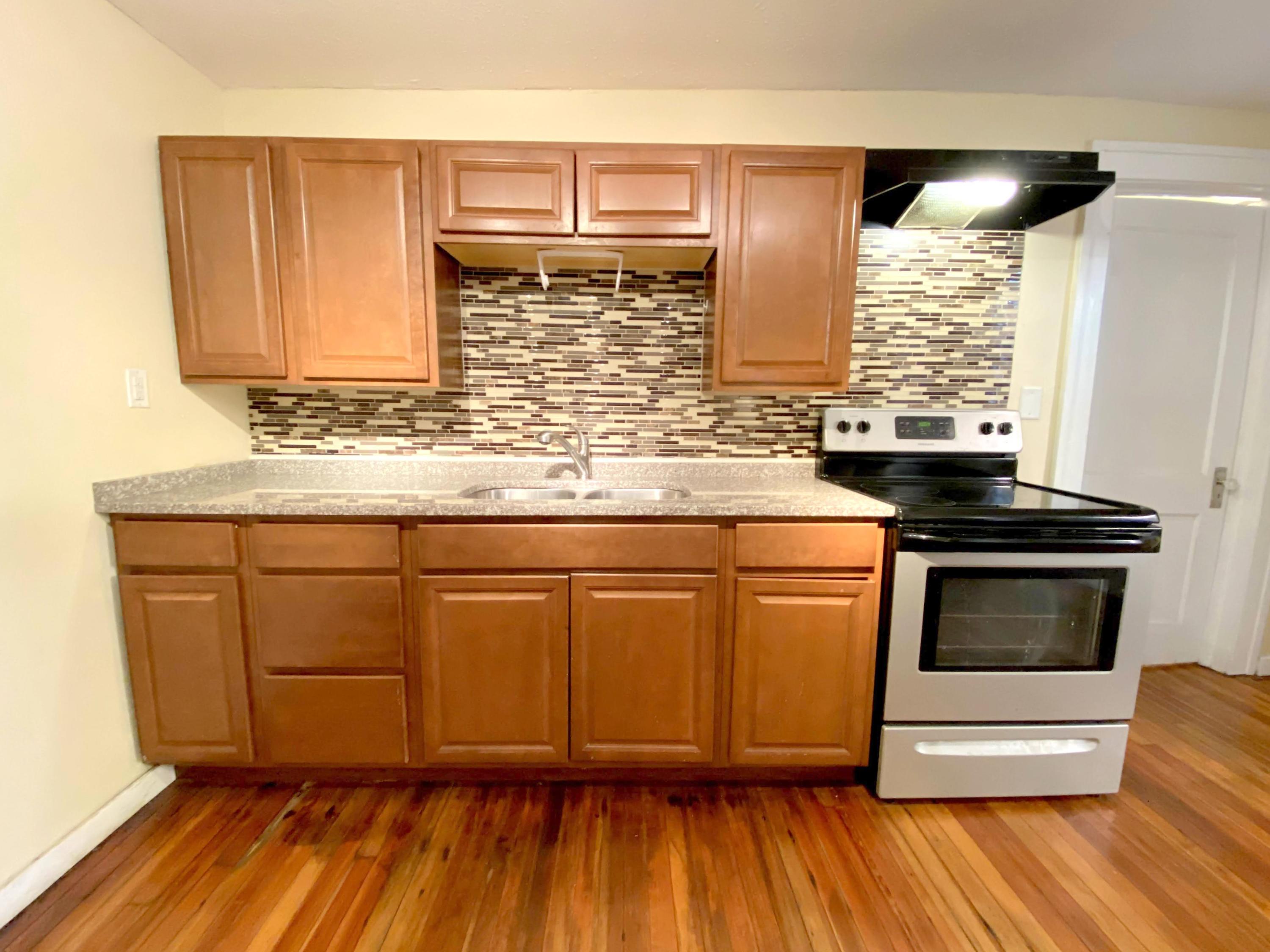 1306 Patterson Avenue Southwest, Unit 3 Roanoke, VA 24016 - Photo 13 of 28 a kitchen with granite countertop wooden cabinets stainless steel appliances and a sink