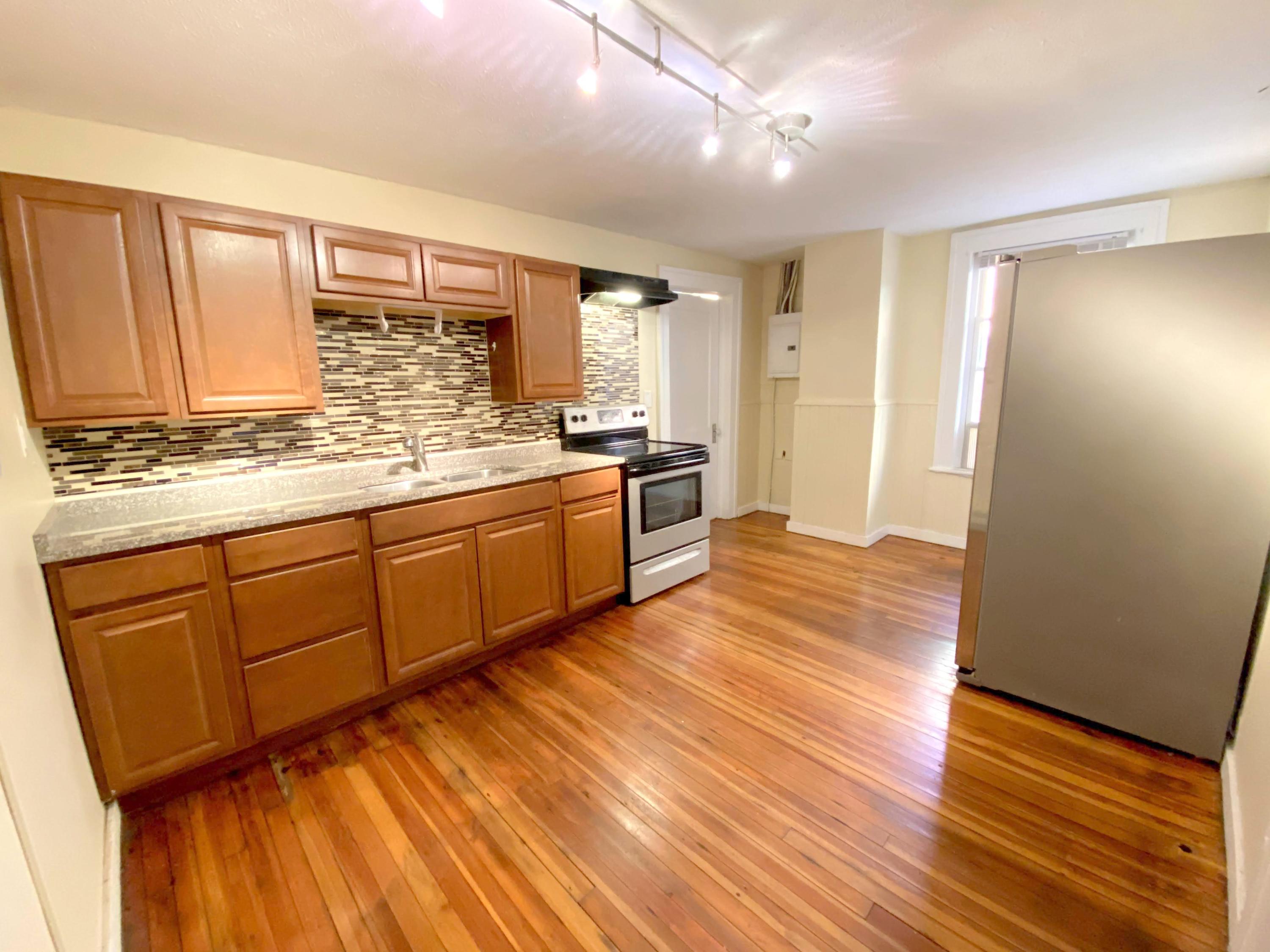 1306 Patterson Avenue Southwest, Unit 3 Roanoke, VA 24016 - Photo 14 of 28 a kitchen with stainless steel appliances granite countertop a sink cabinets and wooden floor