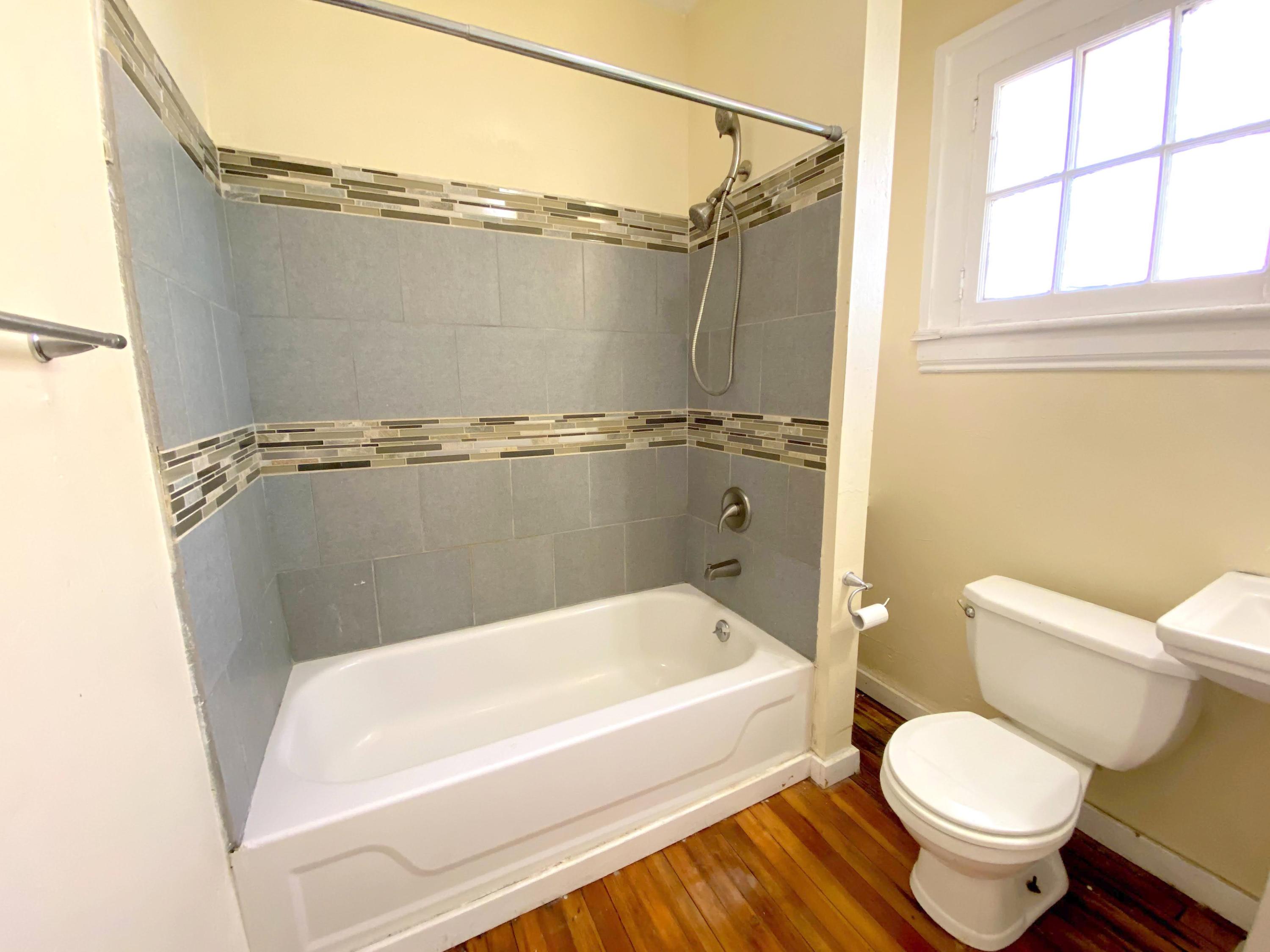 1306 Patterson Avenue Southwest, Unit 3 Roanoke, VA 24016 - Photo 18 of 28 a white toilet sitting next to a bathtub