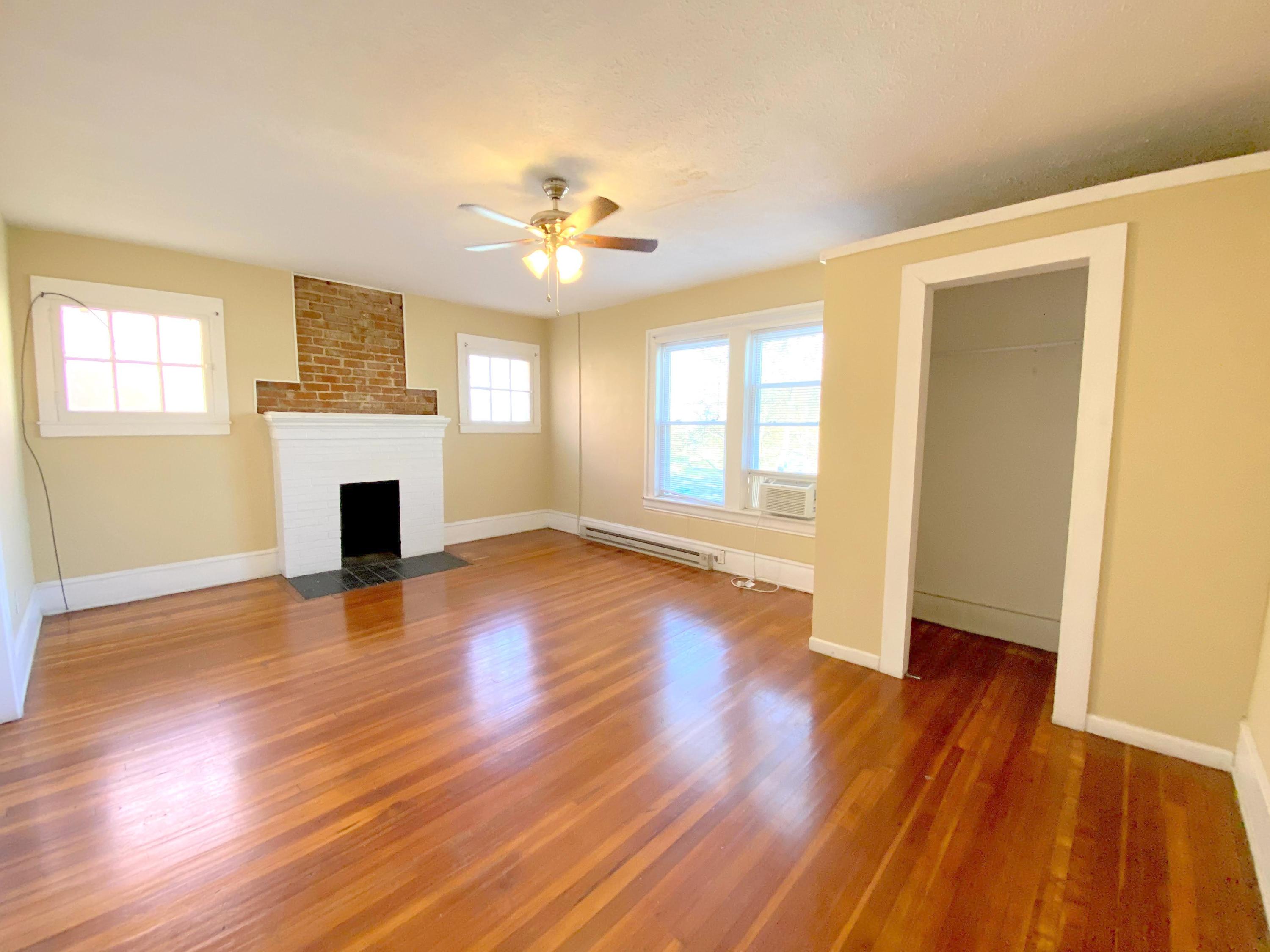 1306 Patterson Avenue Southwest, Unit 3 Roanoke, VA 24016 - Photo 19 of 28 a view of an empty room with wooden floor and a window