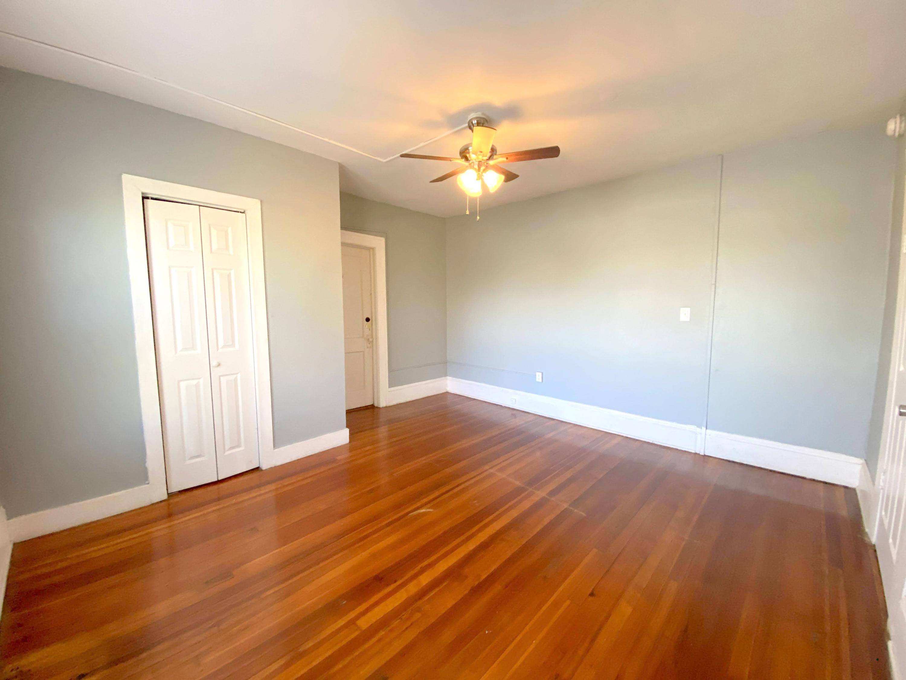 1306 Patterson Avenue Southwest, Unit 3 Roanoke, VA 24016 - Photo 26 of 28 an empty room with wooden floor and fan