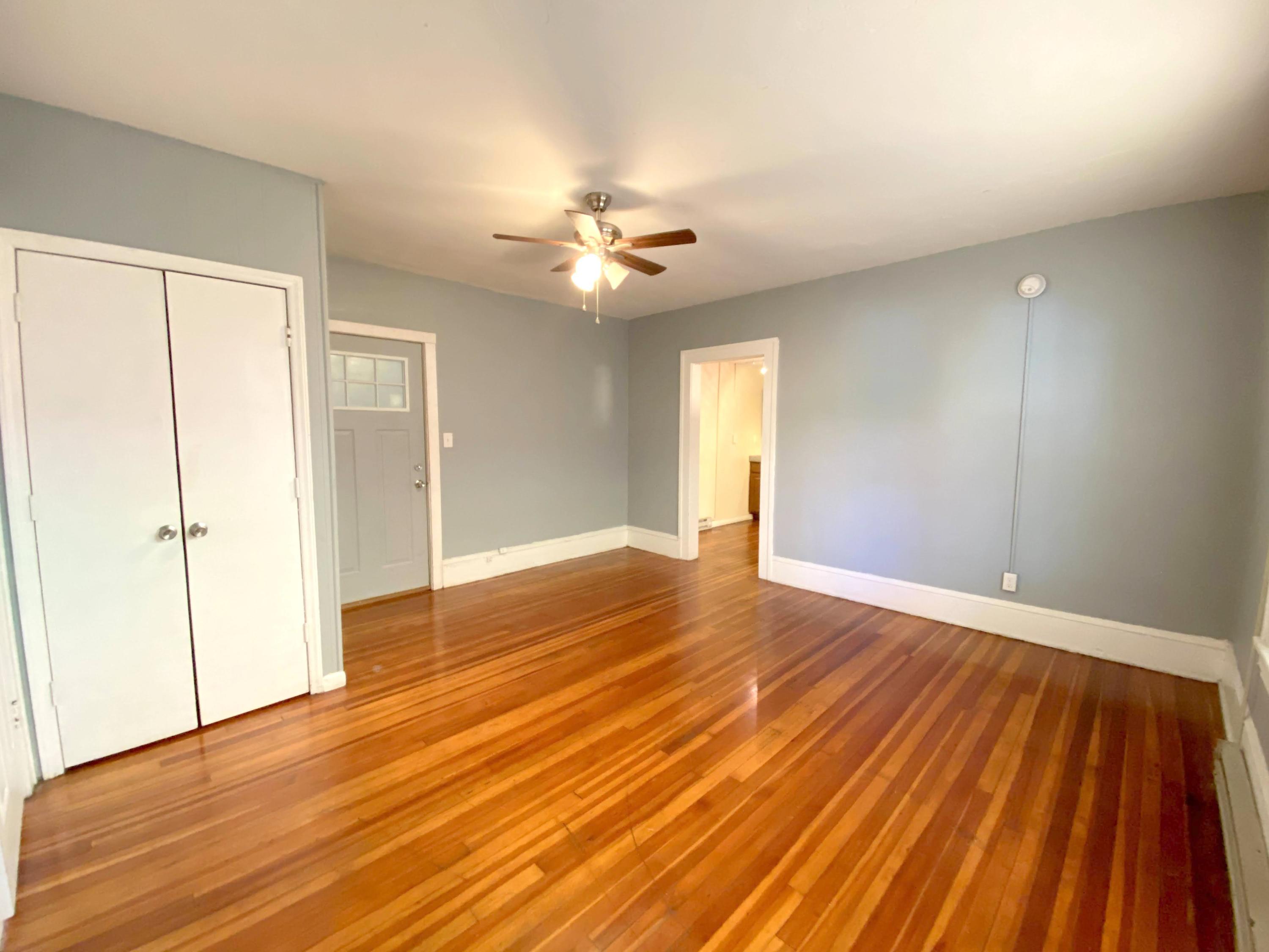 1306 Patterson Avenue Southwest, Unit 3 Roanoke, VA 24016 - Photo 9 of 28 an empty room with wooden floor and windows