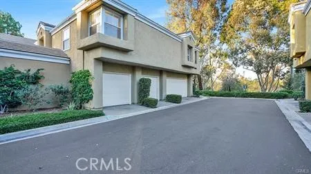 a front view of a house with a yard and a garage