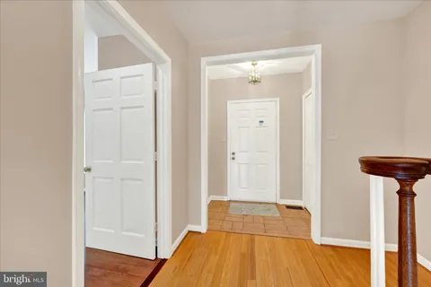 a view of a room with wooden floor and a bathroom