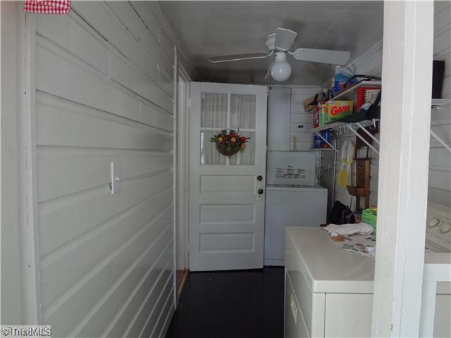 7701 Broad Street Rural Hall, NC 27045 - Photo 12 of 16 Exterior Front. Enclosed back porch with washer and dryer. Dryer stays with property and is a gas dryer.